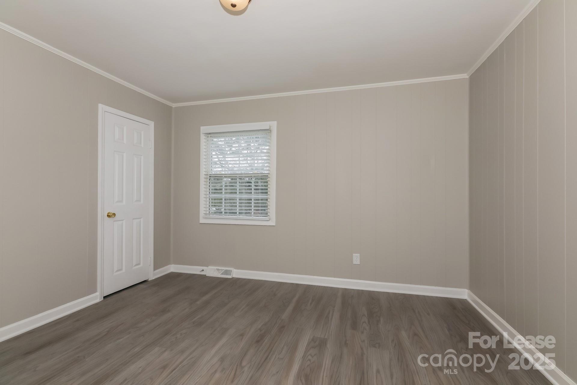 319 Cedarwood Lane Matthews, NC 28104 - Photo 8 of 16 an empty room with wooden floor and windows