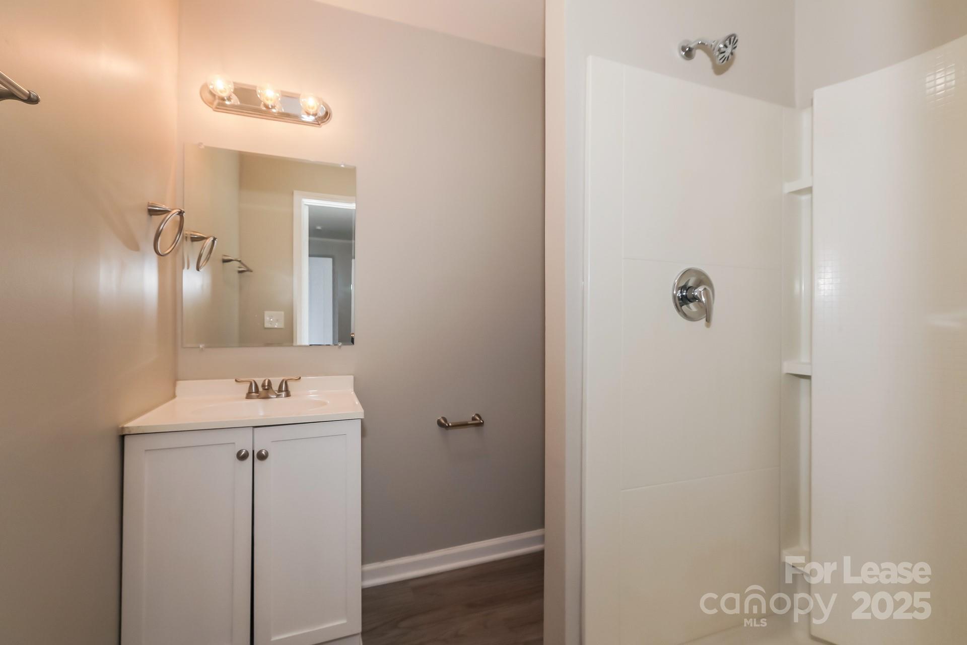 319 Cedarwood Lane Matthews, NC 28104 - Photo 10 of 16 a bathroom with a sink and mirror