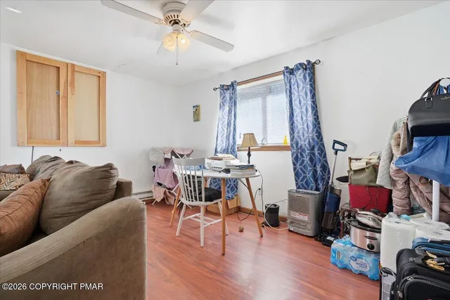 a bedroom with a bed and a flat tv screen on dresser