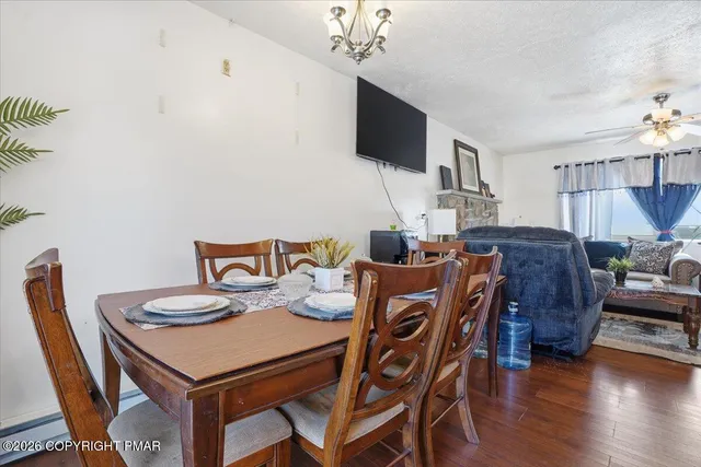 a living room with furniture and a dining table