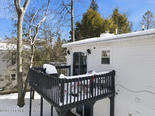 a kitchen with kitchen island granite countertop a stove top oven a sink dishwasher a dining table and chairs with wooden floor