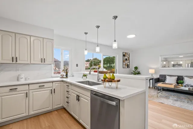 a kitchen with a sink window and cabinets