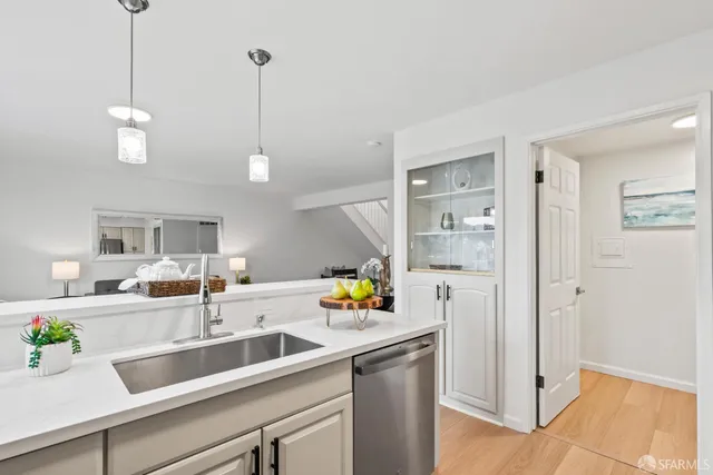 a kitchen with a sink a counter space cabinets and appliances