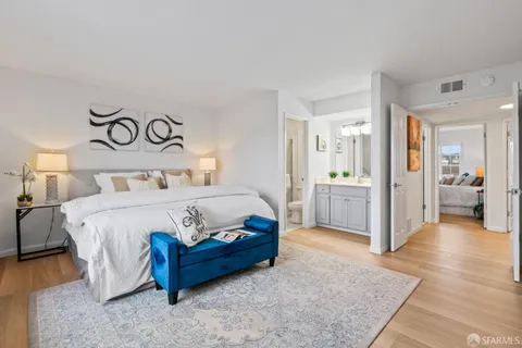 a spacious bedroom with a bed and a view of bathroom