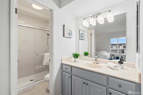 a bathroom with a sink a toilet and shower