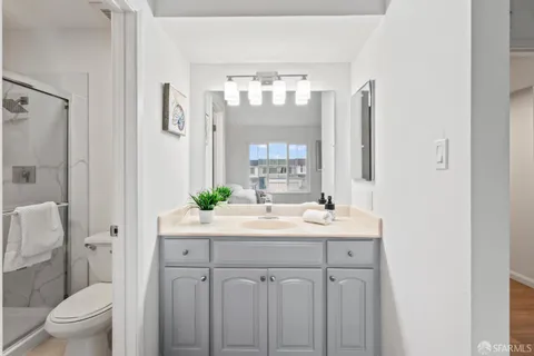 a bathroom with a sink a toilet and a mirror