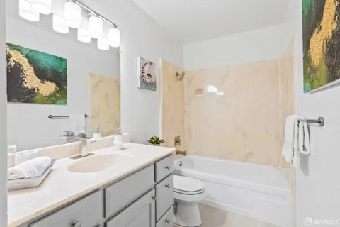 a bathroom with a sink a toilet and bathtub