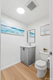 a bathroom with a toilet sink and vanity