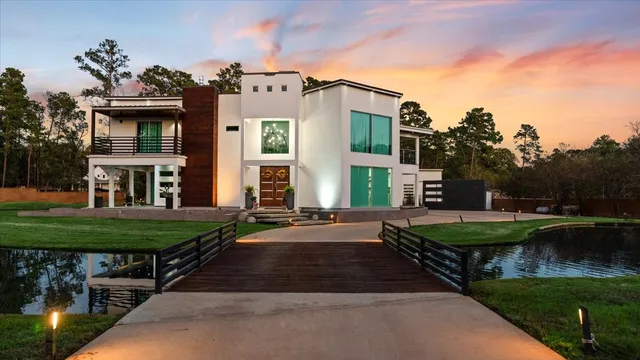 a front view of a house with garden and sitting area