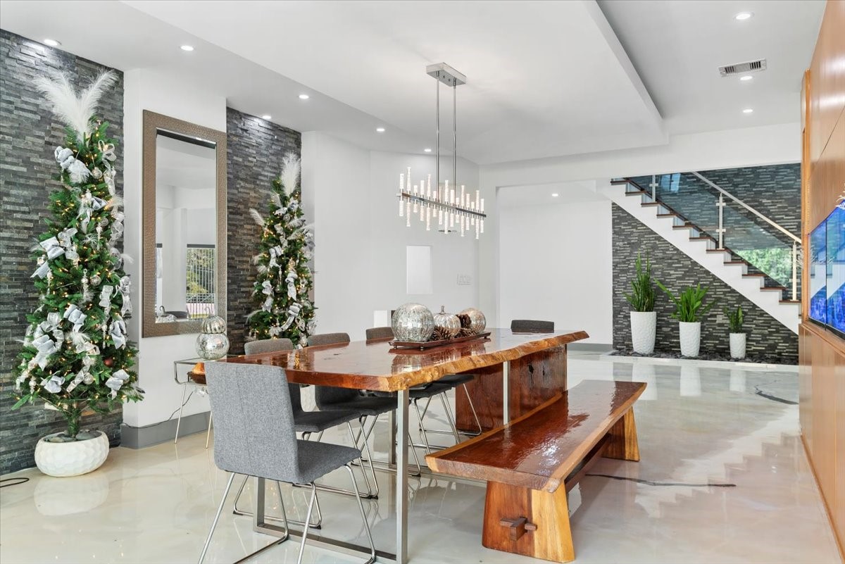 30400 Highland Boulevard Magnolia, TX 77354 - Photo 11 of 50 a dining room with furniture potted plants and wooden floor