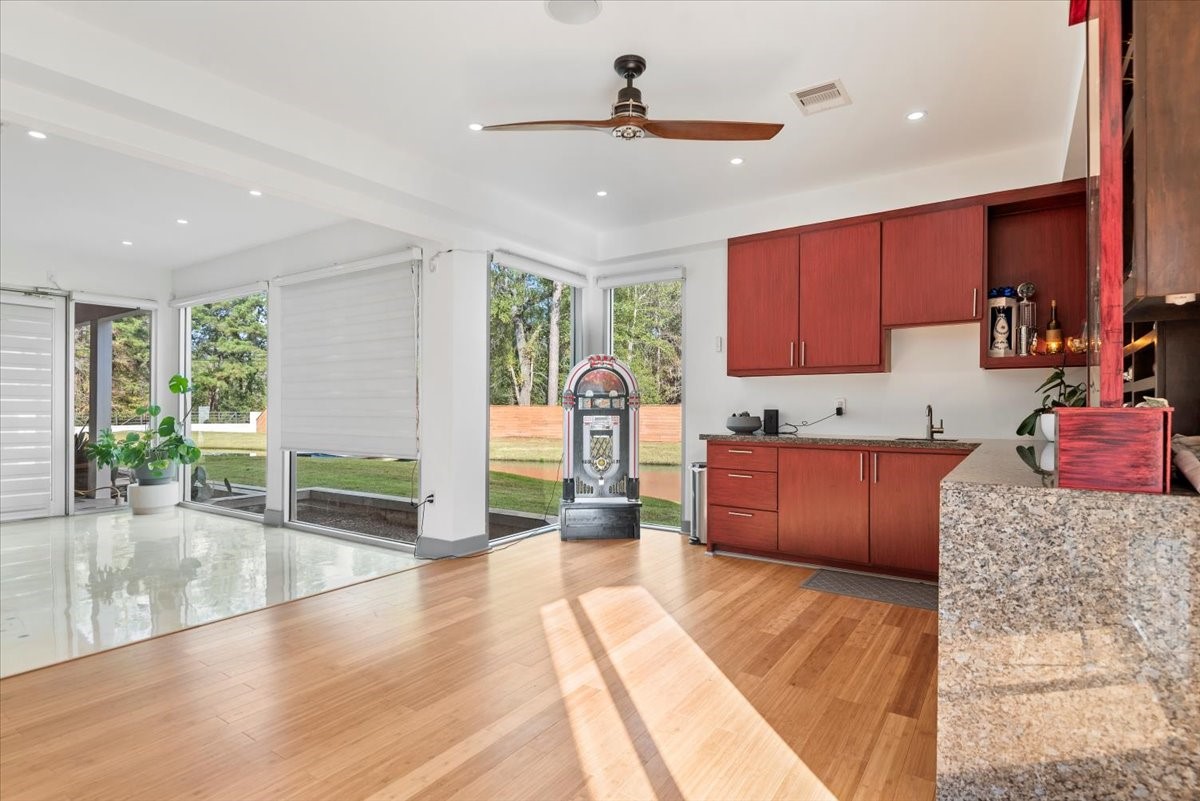 30400 Highland Boulevard Magnolia, TX 77354 - Photo 12 of 50 a kitchen with stainless steel appliances kitchen island granite countertop a stove and cabinets