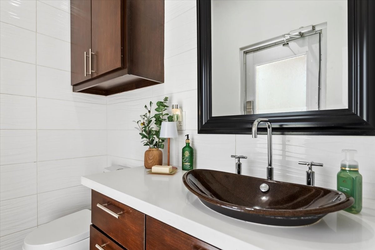 30400 Highland Boulevard Magnolia, TX 77354 - Photo 15 of 50 a bathroom with a sink and a mirror