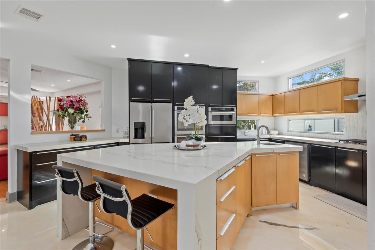 30400 Highland Boulevard Magnolia, TX 77354 - Photo 18 of 50 a kitchen with stainless steel appliances kitchen island granite countertop a sink and cabinets