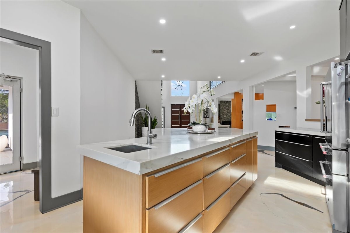 30400 Highland Boulevard Magnolia, TX 77354 - Photo 19 of 50 a kitchen with kitchen island granite countertop a sink and refrigerator