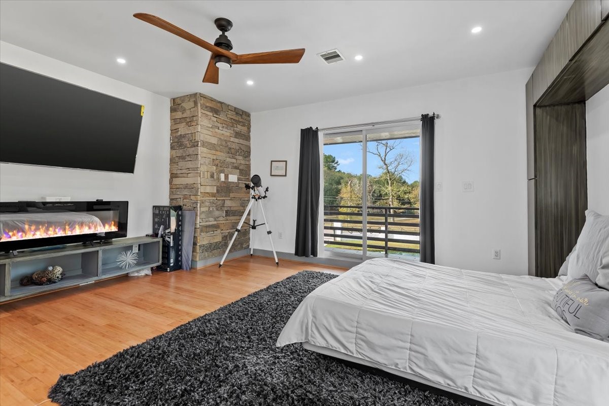 30400 Highland Boulevard Magnolia, TX 77354 - Photo 24 of 50 a bedroom with a bed and a flat screen tv