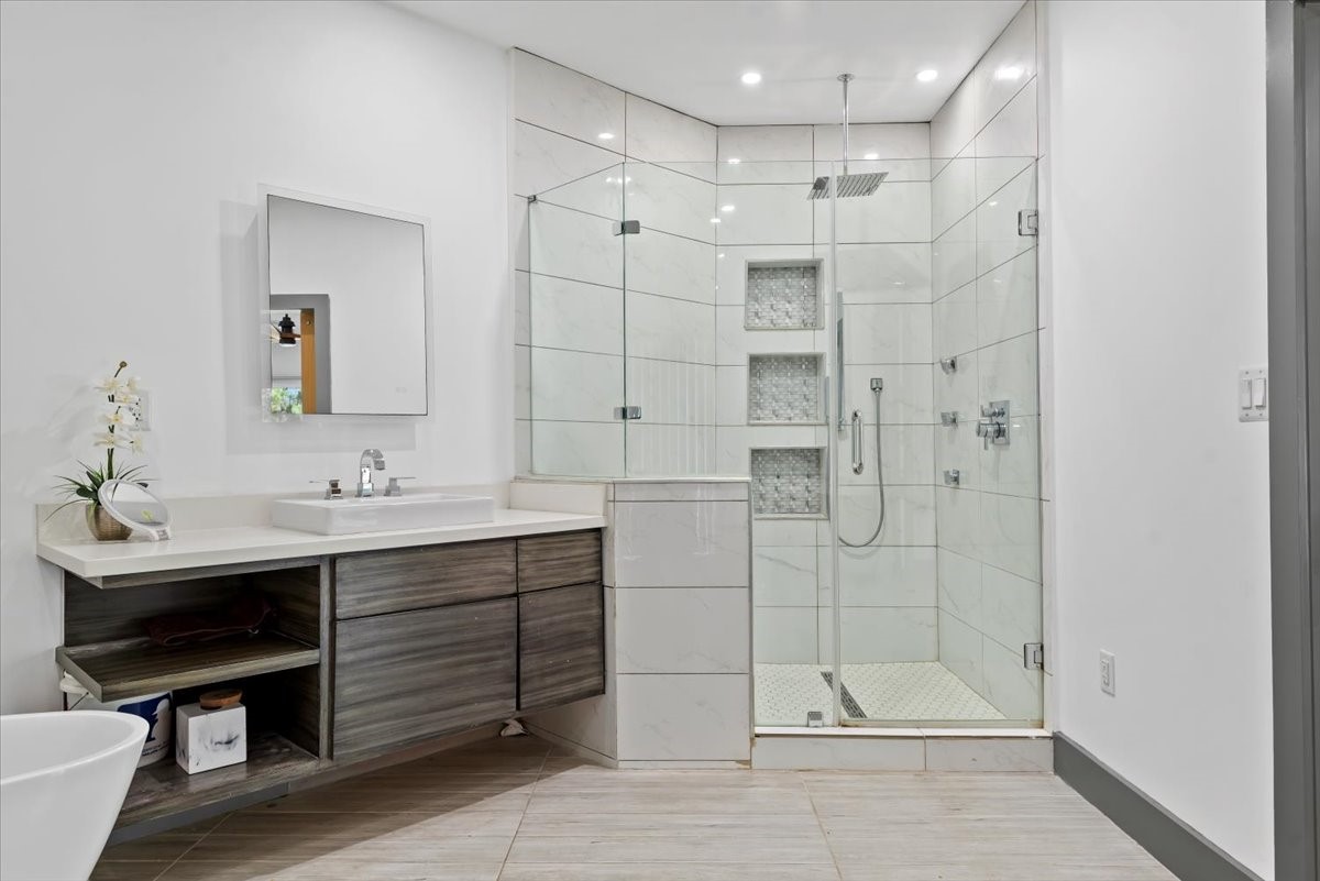 30400 Highland Boulevard Magnolia, TX 77354 - Photo 27 of 50 a bathroom with a double vanity sink mirror and shower