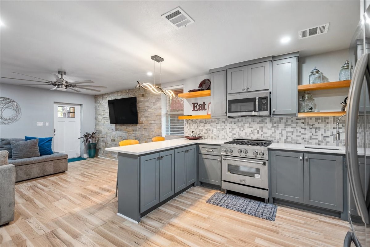 30400 Highland Boulevard Magnolia, TX 77354 - Photo 41 of 50 a kitchen with stainless steel appliances granite countertop a stove and a sink