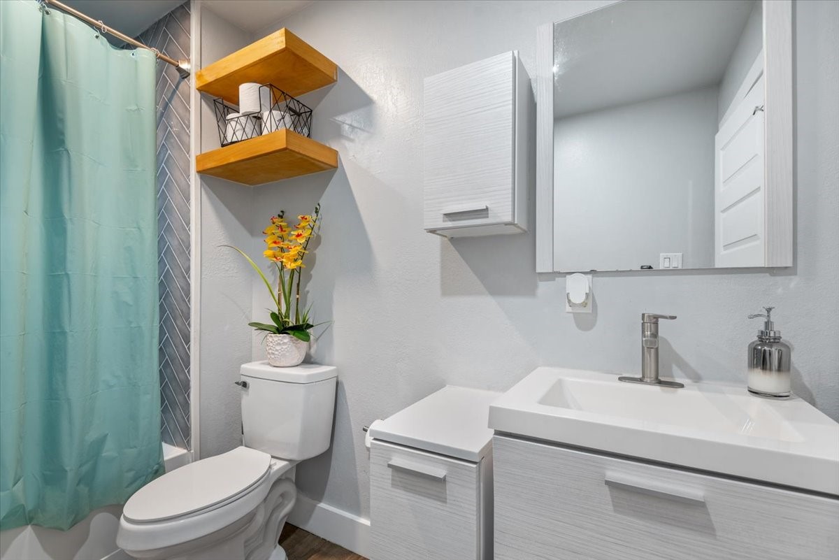 30400 Highland Boulevard Magnolia, TX 77354 - Photo 43 of 50 a bathroom with a sink a toilet and a mirror