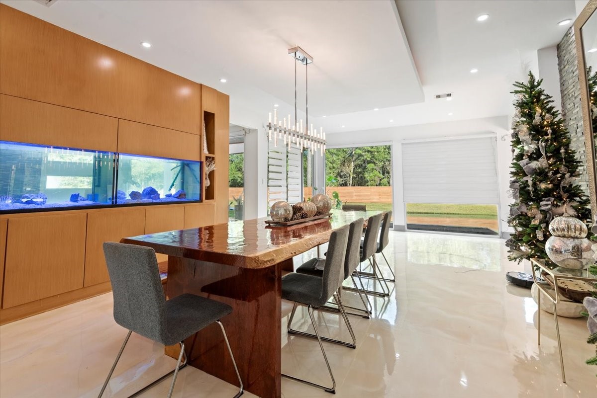 30400 Highland Boulevard Magnolia, TX 77354 - Photo 10 of 50 a dining room with furniture a chandelier and wooden floor