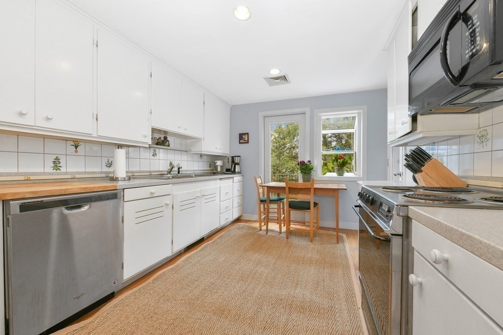 28 Tyler Road Belmont, MA 02478 - Photo 12 of 27 a kitchen with a sink stove and cabinets