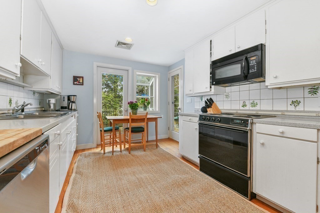 28 Tyler Road Belmont, MA 02478 - Photo 13 of 27 a kitchen with stainless steel appliances a stove sink microwave and cabinets