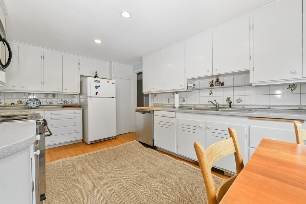28 Tyler Road Belmont, MA 02478 - Photo 14 of 27 a kitchen with stainless steel appliances granite countertop a refrigerator sink and white cabinets