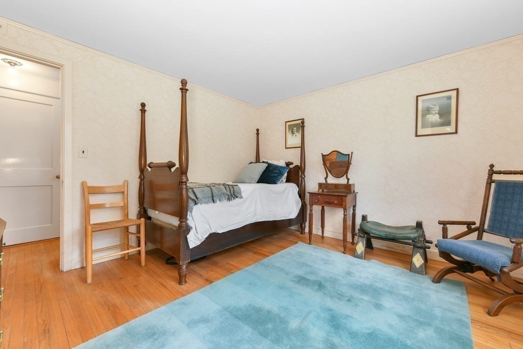 28 Tyler Road Belmont, MA 02478 - Photo 18 of 27 a spacious bedroom with a bed and a chair
