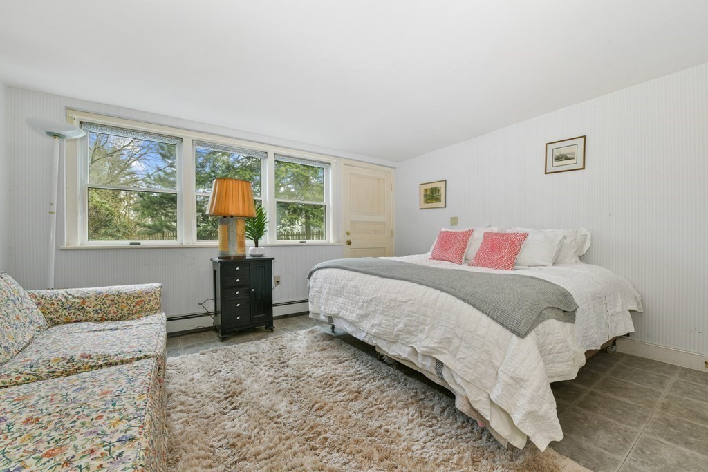 28 Tyler Road Belmont, MA 02478 - Photo 21 of 27 a bedroom with a bed and glass window