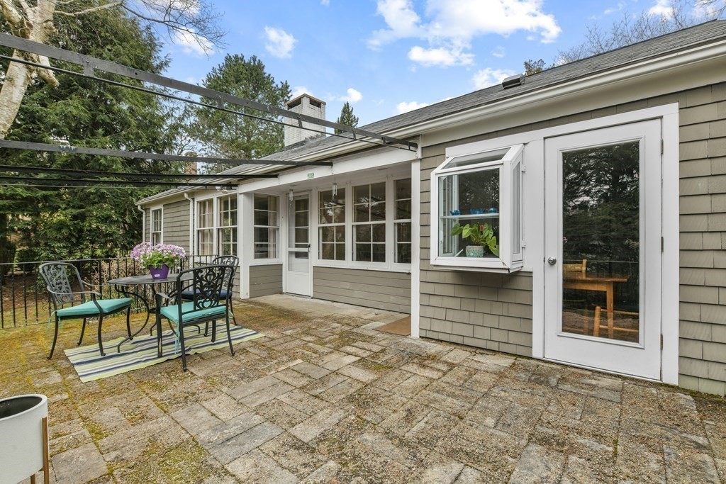 28 Tyler Road Belmont, MA 02478 - Photo 24 of 27 a view of a chair and tables in the back yard of the house