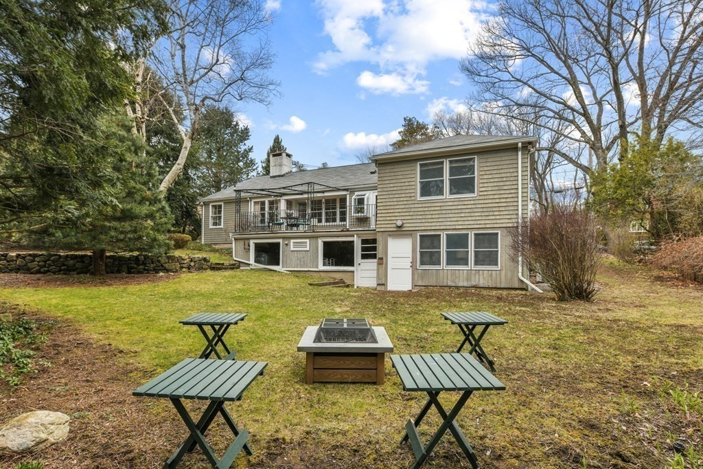 28 Tyler Road Belmont, MA 02478 - Photo 26 of 27 a front view of a house with swimming pool table and chairs