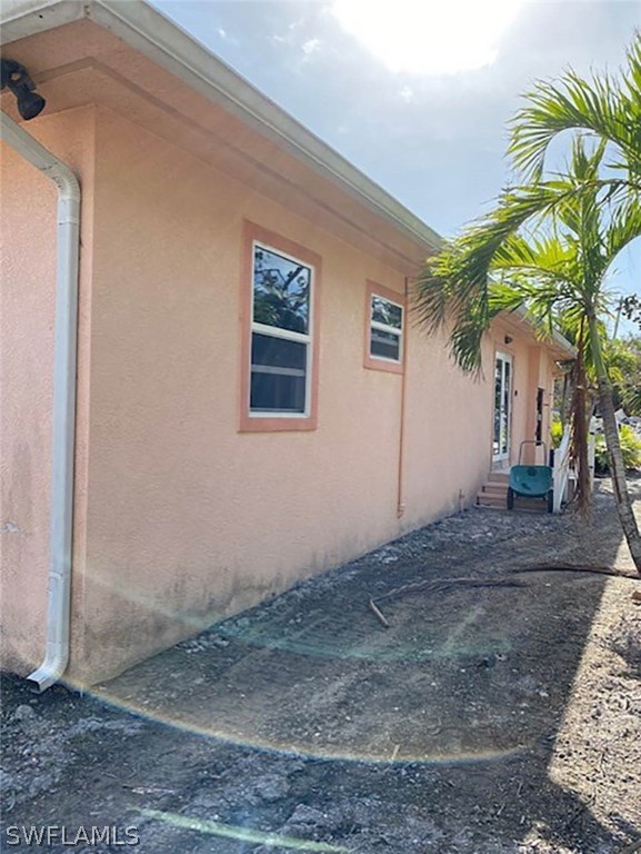 1153 Shell Basket Lane Sanibel, FL 33957 - Photo 2 of 8 a view of a house with a palm tree
