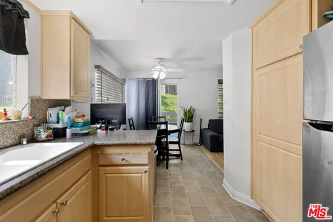 a kitchen with a refrigerator and a sink