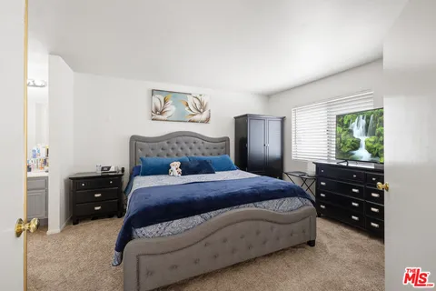 a bedroom with a bed and a closet
