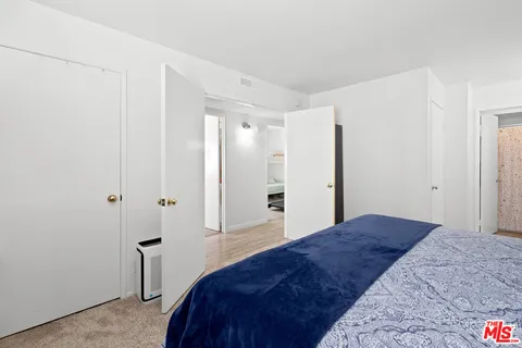a bedroom with a bed and a bathroom