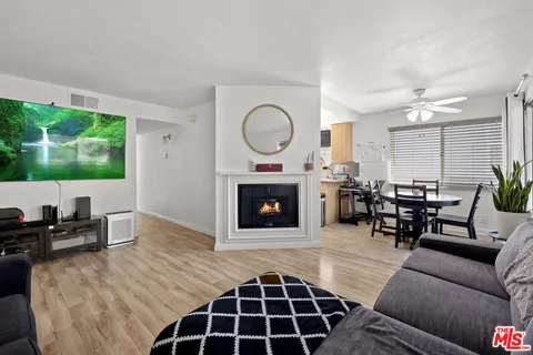 a living room with furniture a window and a fireplace