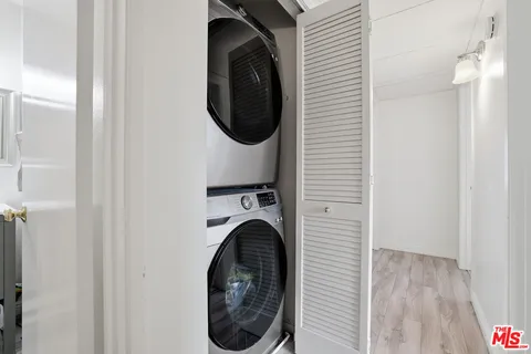 a view of a hallway with washer and dryer