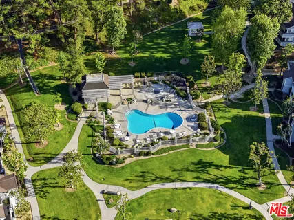 an aerial view of a residential houses with outdoor space