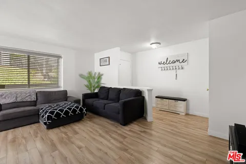 a living room with furniture window and wooden floor