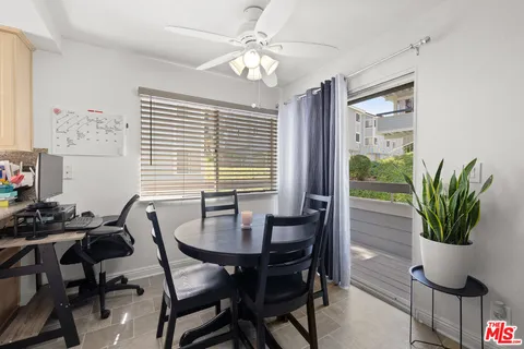 a view of a dining room with furniture and a potted plant