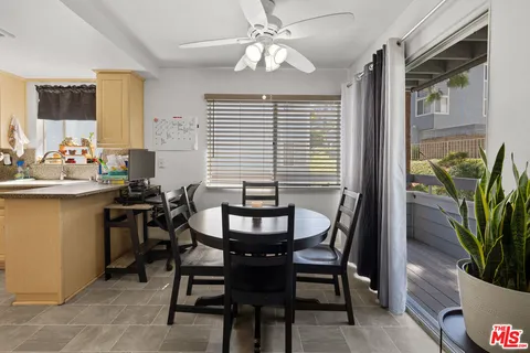 a view of a dining room with furniture and window