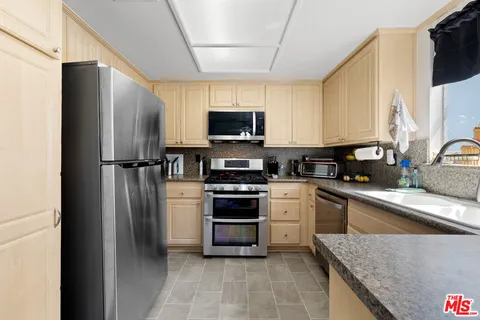 a kitchen with a refrigerator and a sink
