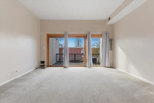 an empty room with an outdoor view and a window