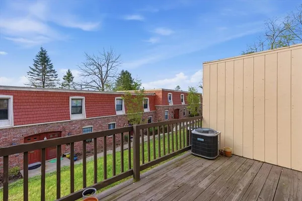 a view of a deck with wooden floor and fence