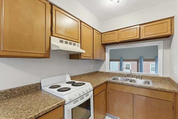 a kitchen with stainless steel appliances granite countertop a sink stove and cabinets