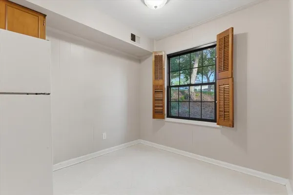 a view of an empty room with a window