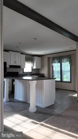 a kitchen with a refrigerator and a stove top oven