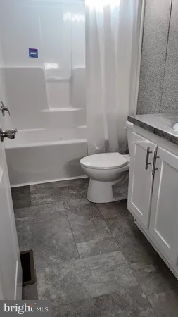 a bathroom with a toilet a sink and bathtub