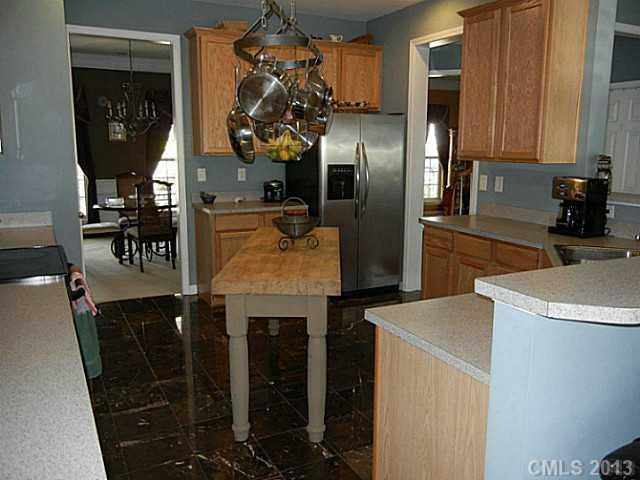 310 Prestmont Court Fort Mill, SC 29708 - Photo 8 of 13 a kitchen with stainless steel appliances granite countertop a refrigerator a stove and a sink