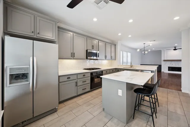 a kitchen with a refrigerator a sink and cabinets