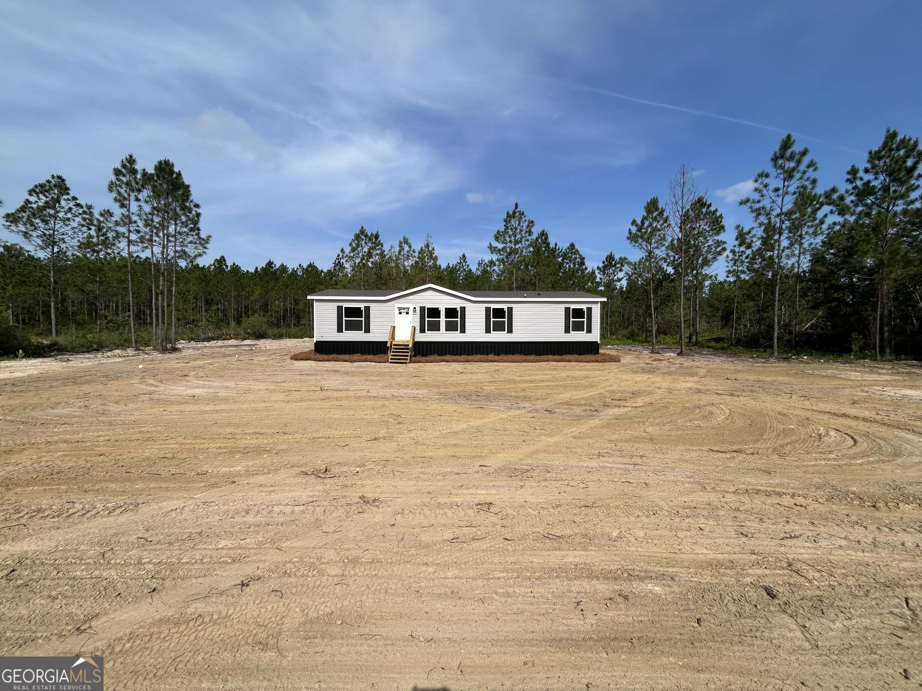 640 Elmer Thrift Road Waycross, GA 31503 - Photo 1 of 23 a view of a swimming pool with buildings in the background